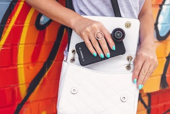 Woman Taking Out a Black Smartphone from a White Crossbody Bag