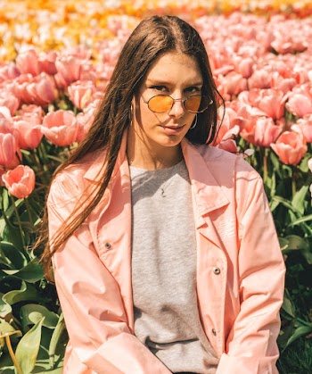 Woman Taking Photo Front of Pink Flower Field