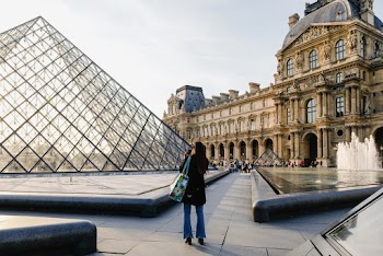 Woman Taking Photo Of Building
