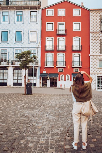 Woman Taking Photo of Buildings