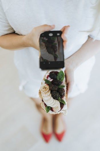 Woman Taking Photo Of Food
