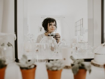 Woman Taking Photo Of Her Reflection 