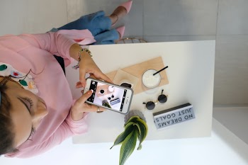 Woman Taking Photo Of Plant and Drink