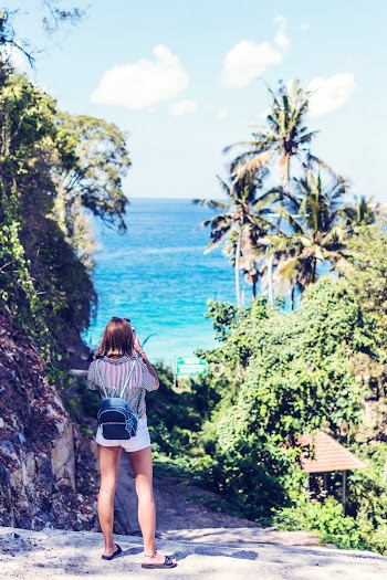 Woman Taking Photo of the Beach