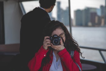 Woman Taking Photograph Beside Man