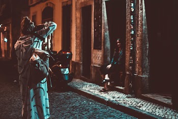 Woman Taking Photograph during Nighttime