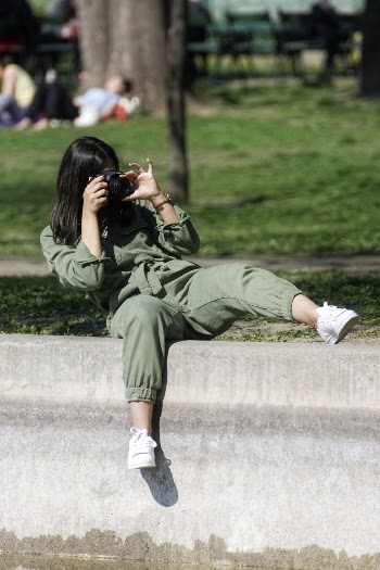 Woman Taking Picture While Sitting