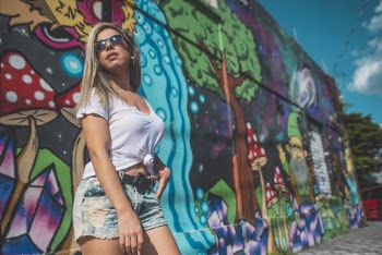 Woman Taking Pose in Front Painted Wall