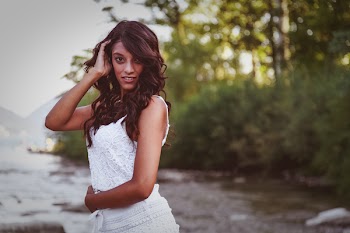 Woman Taking Pose Near River and Trees