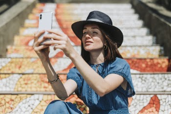 Woman Taking Selfie Beside Concrete Stairs