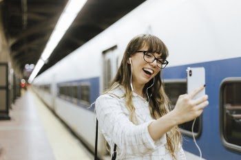 Woman Taking Selfie Beside Train