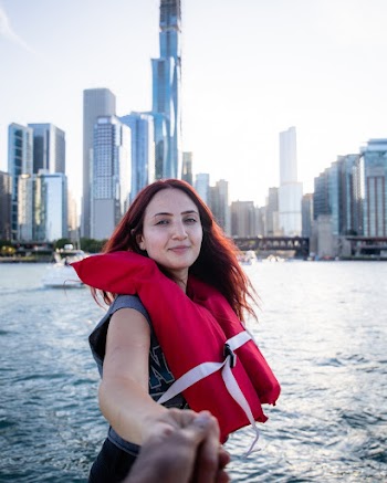 Woman Taking Selfie in Front of High-rise Building Under White Sky