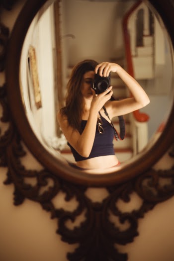 Woman Taking Selfie in Front of Mirror Using Dslr Camera