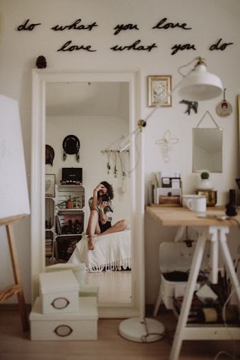 woman taking selfie while sitting on white pad