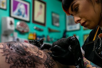 Woman Tattooing  A Person