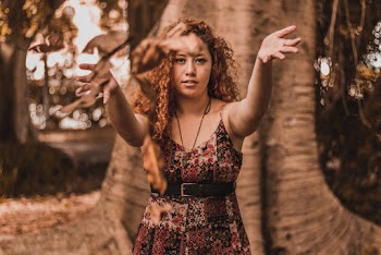 Woman Throwing Dried Leaves