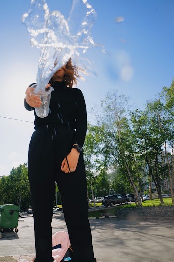 Woman Throwing Water From A Plastic Cup