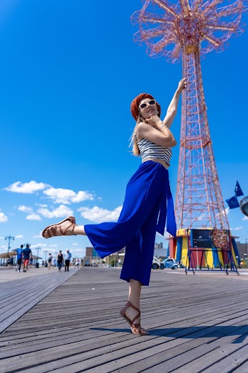 Woman Tiptoeing on Wooden Boardwalk