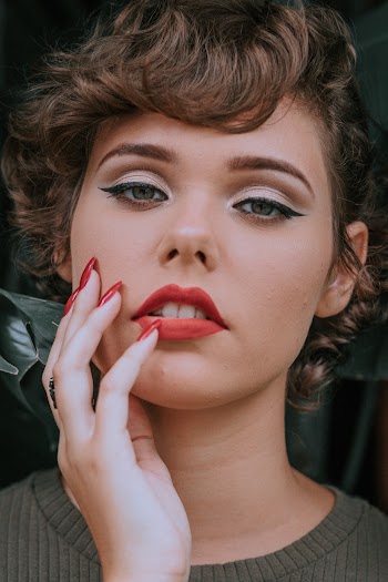 Woman Touching Face With Right Hand