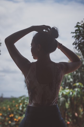 Woman Touching Head Near Green-leafed Plants Outdoors