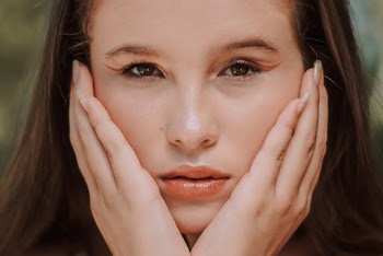 Woman Touching Her Face