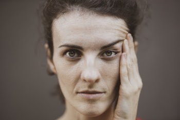 Woman Touching Her Face