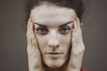 Woman Touching Her Face