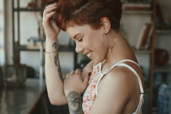 Woman Touching Her Hair And Smiling