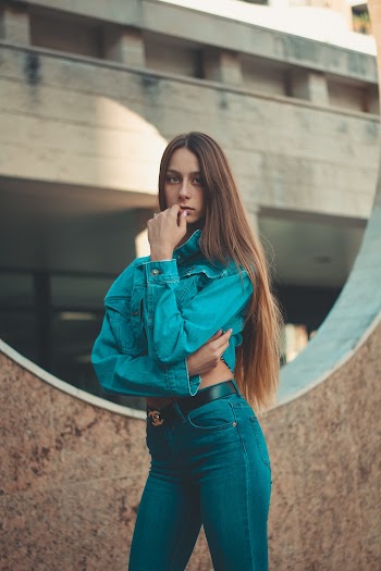 Woman Touching Her Lips While Standing Near Wall