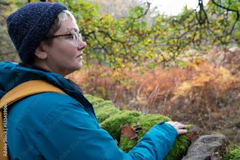 Woman touching moss in forest