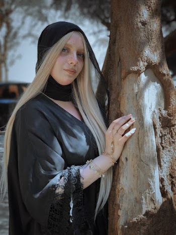 Woman Touching Tree Trunk