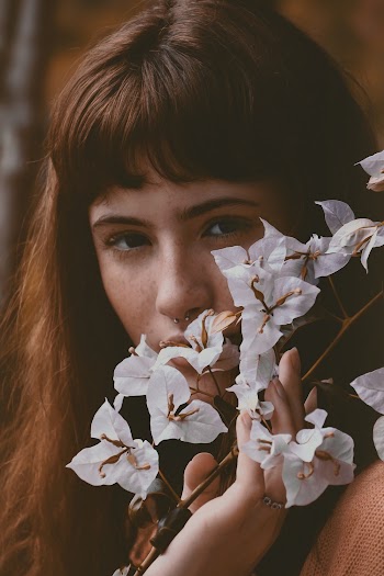 Woman Touching White Petaled Flower