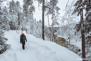 Woman trekking through a snow covered Lapland, Finland