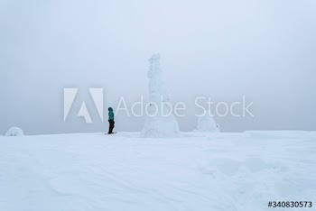 Woman trekking through a snow covered Lapland, Finland