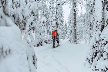 Woman trekking through a snow covered Lapland, Finland