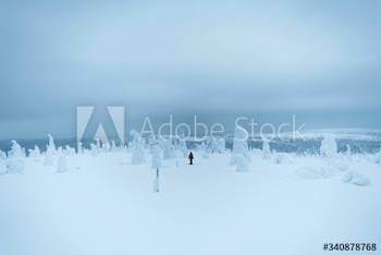 Woman trekking through a snow covered Lapland, Finland