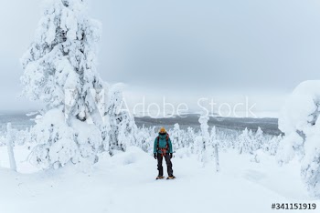 Woman trekking through the snow in  Lapland, Finland