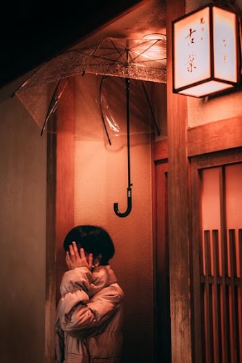 woman under clear plastic umbrella