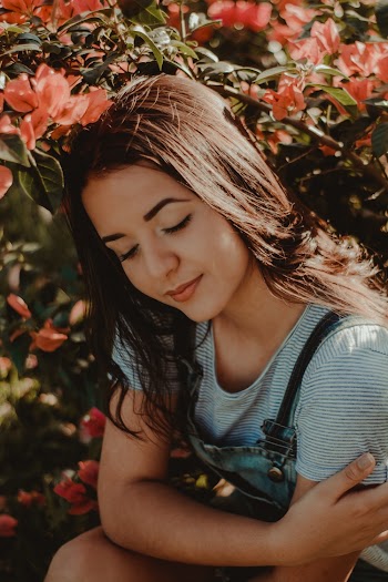 Woman Under Red Bougainvillea Plant