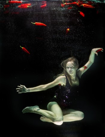 Woman Underwater Wearing Black One Piece Swimsuit