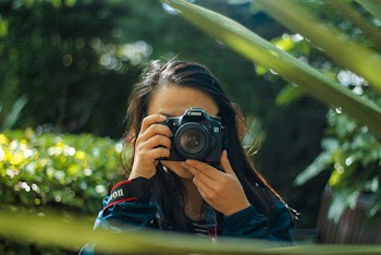 Woman Using A Dlsr Camera