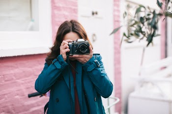 Woman Using Black Dslr Camera