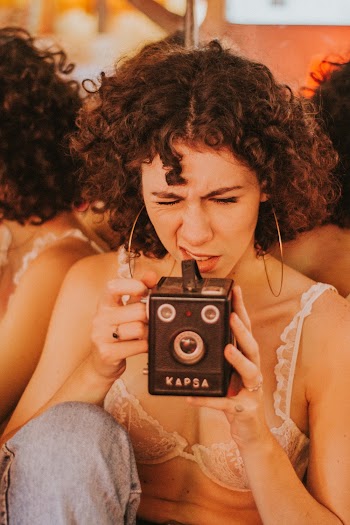 Woman Using Black Kapsa Camera