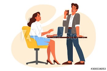 Woman using computer and talking to her coworker