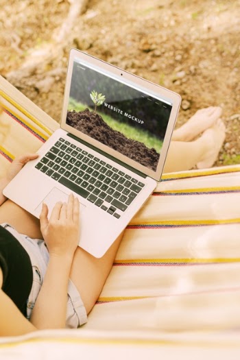 Woman using laptop mockup in nature Free Psd