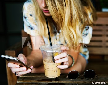 Woman using mobile phone and chill out at cafe
