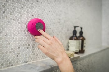 Woman Using Shower Speaker