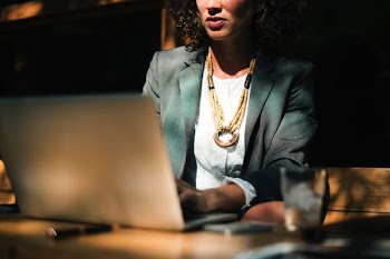 woman using silver laptop computer