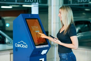 Woman Using Smart Parking Kiosk in Modern Parking Garage