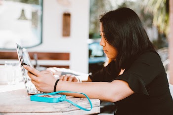 Woman Using Smartphone and Laptop